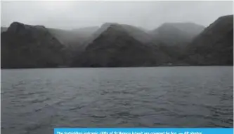  ?? — AP photos ?? The forbidding volcanic cliffs of St Helena island are covered by fog.