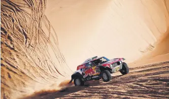  ??  ?? Stephane Peterhanse­l and his co-driver Portuguese Paulo Fiuza compete during stage 11 of the rally between Shubaytah and Haradh, Saudi Arabia, Jan. 16, 2020.