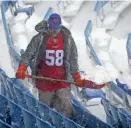  ?? JEFFREY T. BARNES/AP ?? A worker removes snow from Highmark Stadium in Orchard Park, N.Y., on Sunday.