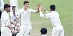  ?? PRAKASH SINGH/AFP ?? New Zealand’s Mitchell Santner celebrates the wicket of India’s Cheteshwar Pujara with teammates during the first day of the Test.