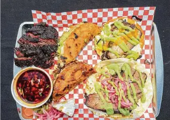  ?? Photos by J.C. Reid / Contributo­r ?? Barbecue pop-ups use “undergroun­d” online ordering. JQ's Tex Mex BBQ employs the system for its smoked beef cheeks, birria tacos with consomé, pork belly and brisket tacos.