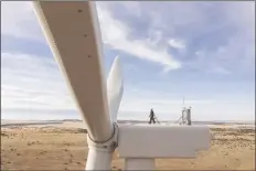  ?? RICH CROWDER/AP ?? THIS UNDATED IMAGE PROVIDED BY GE VERNOVA shows a worker atop a wind turbine at the Borderland Wind Project in western New Mexico near the Arizona state line. GE Vernova has received a record order for 674 turbines that will be used for the Sunzia Wind Project in central New Mexico, which is expected to be the largest wind farm in the Western Hemisphere when it comes online in 2026.