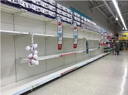  ??  ?? Cleared out: Empty toilet roll shelves in Tesco Newbridge