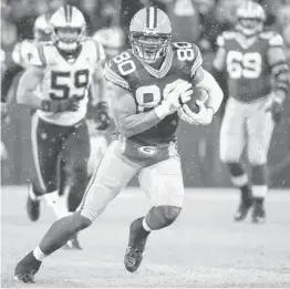  ?? MATT LUDTKE/AP ?? Packers tight end Jimmy Graham runs after a catch against the Panthers on Nov. 11.