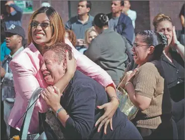  ?? (AP/Ernesto Mora) ?? Two women hold each other as they watch the World Trade Center burn in New York on Sept. 11, 2001.