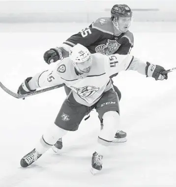  ?? (AP PHOTO/WILFREDO LEE) ?? Nashville Predators defenseman Alexandre Carrier (45) and Florida Panthers center Noel Acciari race for the puck during the third period Saturday in Sunrise.