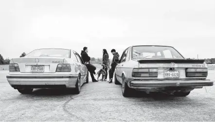  ??  ?? Photos by Michael Wyke / Contributo­r
Blake Francis, above, from left, Marium Murphy and her dog Buttercup, and Samuel Leisey chat as they lean on their cars between runs during the Sidewayz Cartel’s December track meet held at the Houston Police Academy training track. Francis drives a silver ’97 BMW, and Leisey drives a tan ’87 BMW. Thomas Haye, far left, adds his skid marks to the burnout box while doing doughnuts.