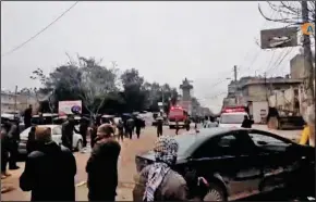  ?? ANHA/AFP/GETTY IMAGES ?? An image grab taken from a video published by Hawar News Agency (ANHA) on Wednesday shows people gathered at the scene of a suicide attack in the northern Syrian town of Manbij.