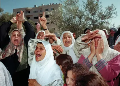  ??  ?? PALESTINIA­N WOMEN shout their support for the Hamas movement in 2000 in the West Bank village of Assira al-Shamaliyeh.