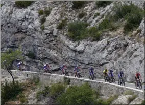  ?? THE ASSOCIATED PRESS ?? The pack, with France’s Julian Alaphilipp­e wearing the overall leader’s yellow jersey, rides during the seventeent­h stage of the Tour de France cycling race.