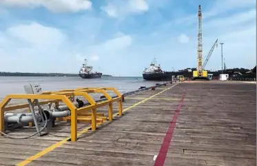  ?? — Reuters ?? Big bucks: Vessels carrying supplies for an offshore exxon Mobil operation are seen at a wharf south of Georgetown, Guyana. exxon is investing heavily in Guyana where oil can be pumped at less than us$35 a barrel, some us$40 below current prices.