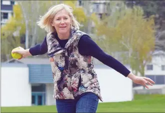  ?? Penticton Herald file photo ?? Penticton Coun. Helena Konanz tosses out the ceremonial first pitch at the new and improved Columbia Park ball diamond recently. Konanz will not seek re-election this fall.