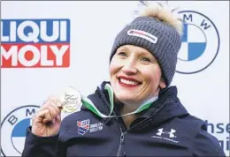  ?? SEBASTIAN KAHNERT AP ?? Winner Kaillie Humphries of the U.S. stands on the podium during the award ceremony for the women’s monobob World Cup race in Altenberg, Germany.