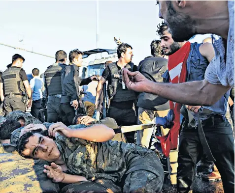  ??  ?? Troops surrenderi­ng on the Bosphorus Bridge, above, and below Taksim Square, Istanbul, after the coup