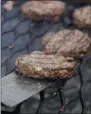  ?? CAROLYN KASTER — ASSOCIATED PRESS FILE ?? A 2011 photo shows hamburgers on a grill in Washington.