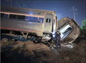  ?? THE ASSOCIATED PRESS ?? Emergency personnel work at the scene of a deadly train wreck on May 12 in Philadelph­ia.