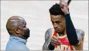  ?? WILFREDO LEE/ASSOCIATED PRESS ?? Interim head coach Nate Mcmillan greets John Collins before Tuesday’s game in Miami, which the Hawks won 94-80. Players have been hesitant to blame the team’s struggles on the fired Lloyd Pierce, but they’re receptive to a fresh start with Mcmillan.