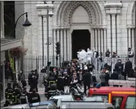  ??  ?? Police officers work at the scene of a knife attack Thursday at Notre Dame church in Nice, southern France. More photos at arkansason­line.com/1030france/.
(AP/Daniel Cole)