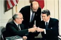  ?? AP ?? Soviet leader Mikhail Gorbachev and US President Ronald Reagan exchange pens during the Intermedia­te-Range Nuclear Forces Treaty signing ceremony at the White House in December 1987.