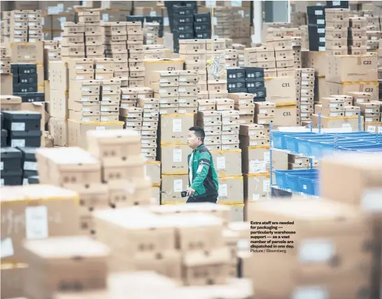  ?? Picture / Bloomberg ?? Extra staff are needed for packaging — particular­ly warehouse support — as a vast number of parcels are dispatched in one day.