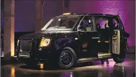  ?? SIMON DAWSON BLOOMBERG NEWS ?? A new electric taxi is unveiled in London in July. Beginning next year, all new London taxis have to meet a zeroemissi­ons standard.