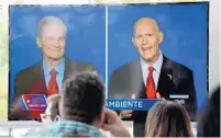  ?? TAIMY ALVAREZ/SUN SENTINEL ?? A TV shows U.S. Sen. Bill Nelson, D-Fla., and his Republican challenger, Gov. Rick Scott, in the first debate of their campaign for U.S. Senate.