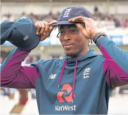  ?? Picture: Getty Images. ?? Jofra Archer tries on his Test cap.