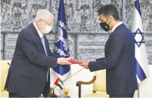  ?? (Mark Neyman/GPO) ?? PRESIDENT REUVEN RIVLIN receives diplomatic credential­s from the first ambassador of the United Arab Emirates to Israel, Muhammad Mahmoud Al Khaja, at the President’s Residence yesterday. See story, Page 2.