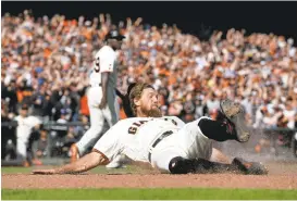  ?? JOSE CARLOS FAJARDO/STAFF ?? Hunter Pence scores on a single by Brandon Crawford in the eighth inning Sunday at AT&T Park. The Giants defeated the Dodgers 7-1 to clinch a National League wild-card spot.