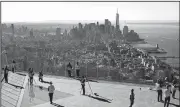  ?? AP/MARK LENNIHAN ?? People walk around the Edge, an outdoor observatio­n deck overlookin­g New York, during a media tour Thursday. Thrill-seeking visitors in New York’s Hudson Yards neighborho­od will be able to get expansive views from the 100-story-high deck early next year.