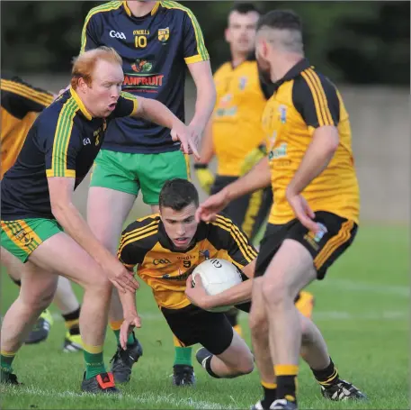 ??  ?? Aonghus Giggins, Stabannon gets in his challenge as Michael McCabe, Cuchulainn Gaels loses his footing. Pictures: Ken Finegan