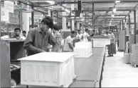  ?? XINHUA ?? Employees work at a refrigerat­or production plant of Haier Group in Lahore, Pakistan.