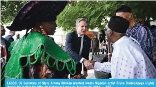  ?? AFP ?? LAGOS: US Secretary of State Antony Blinken (center) meets Nigerian artist Bruce Onobrakpey­a (right) during his visit to the Nike Art Gallery in Lagos on January 24, 2024. —