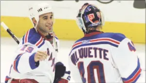  ?? John Amis / Associated Press ?? The New York Rangers’ Scott Gomez, left, celebrates with goalie Steve Valiquette after they beat the Atlanta Thrashers 3-2 in overtime in 2008.