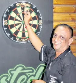  ??  ?? Ricky Bhudu collects his darts, obviously pleased with the outcome Richard Springorum