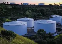  ?? David Paul Morris / Bloomberg ?? Fuel storage tanks stand at the Nustar Energy Selby Terminal in Crockett, Calif. The San Antonio-based pipeline operator saw a $42 million profit from January through March.