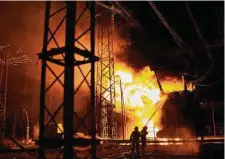  ?? Kostiantyn Liberov/Associated Press ?? Ukrainian firefighte­rs extinguish a blaze after a Russian rocket attack hit an electric power station Sunday in Kharkiv.