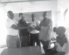  ??  ?? Reeds Dube handing over a soccer ball at Nekatambe Secondary school