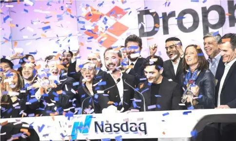  ?? — WP-Bloomberg photo ?? Houston, chief executive officer and co-founder of Dropbox., centre, and Ferdowsi, co-founder of Dropbox, centre right, react during the company’s initial public offering at the Nasdaq MarketSite in New York on Mar 23.