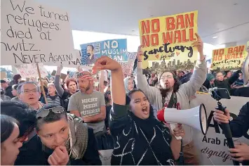  ?? — AP ?? Protesters gather at San Francisco Internatio­nal Airport to denounce President Donald Trump’s executive order that bars citizens of seven predominan­tly Muslim nations from entering the US