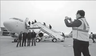  ?? LM OTERO / AP ?? American Airlines employees pose for a photo in front of a 737 Max jet plane before taking off with members of the media from Dallas Fort Worth airport in Grapevine, Texas, on Wednesday.