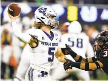  ?? RONALD MARTINEZ GETTY IMAGES ?? Third-string quarterbac­k Cooper Legas rallied Utah State to victory in the LA Bowl on Saturday after starter Logan Bonner was hurt.