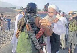  ?? AP FILE ?? ■ Taliban fighters celebrate the Eid ceasefire with residents of Nangarhar province on June 16.