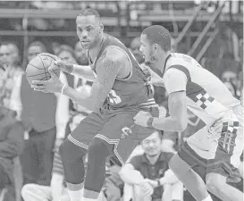  ?? Houston Chronicle file ?? Cavaliers star LeBron James, left, can expect to receive defensive attention from more than just Rockets forward Trevor Ariza in Thursday night’s clash.