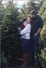  ?? ?? LEFT: Dylan Klawitter has to rearrange Christmas tree inventory for more space at Alpine Christmas Trees on Wible Road. Alpine, which sources trees from Oregon, has five lots in Kern County and provides some of the taller Christmas trees one might see around town, including the 25-foot tree at Valley Baptist. RIGHT: Sylvia and Zachary Seaton pose for a family photograph with their son Jackson after they pick their Christmas tree at an Alpine Christmas Trees lot.