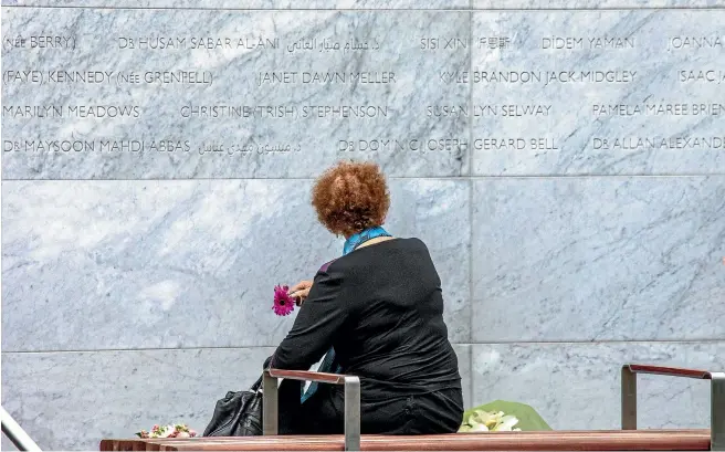  ?? PHOTO: STACY SQUIRES/FAIRFAX NZ ?? A lone reflection on the 185 names on the new memorial wall during the sixth anniversar­y of the Christchur­ch earthquake.