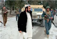  ?? AFP ?? Governor of Bati Kot District of Nangarhar Province Haji Ghalib walks with officials as he inspects security outposts in Bati Kot. —