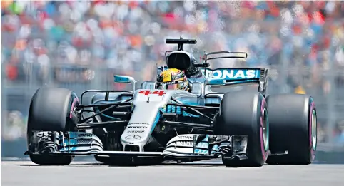  ??  ?? Golden moment: Lewis Hamilton secures his 65th pole position, and celebrates (right) with one of Senna’s old helmets