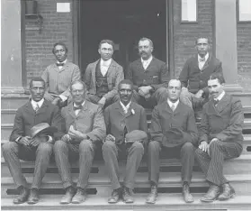  ?? LIBRARY OF CONGRESS 1902 ?? George Washington Carver, front row, center, seated with other staff members on the steps of Tuskegee Normal and Industrial Institute in Tuskegee, Alabama.