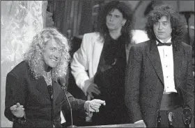  ?? Democrat-Gazette file photo ?? Robert Plant (left) speaks at Led Zeppelin’s induction into the Rock and Roll Hall of Fame in 1995. The group’s lead singer, Plant was joined onstage by guitarist Jimmy Page (right). Aerosmith’s Steve Tyler is at center.